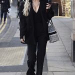 Olivia Attwood puts on a stylish display in a plunging black blazer and a Chanel pearl necklace as she goes furniture shopping in Manchester